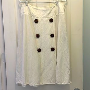 White linen skirt with decorative buttons.